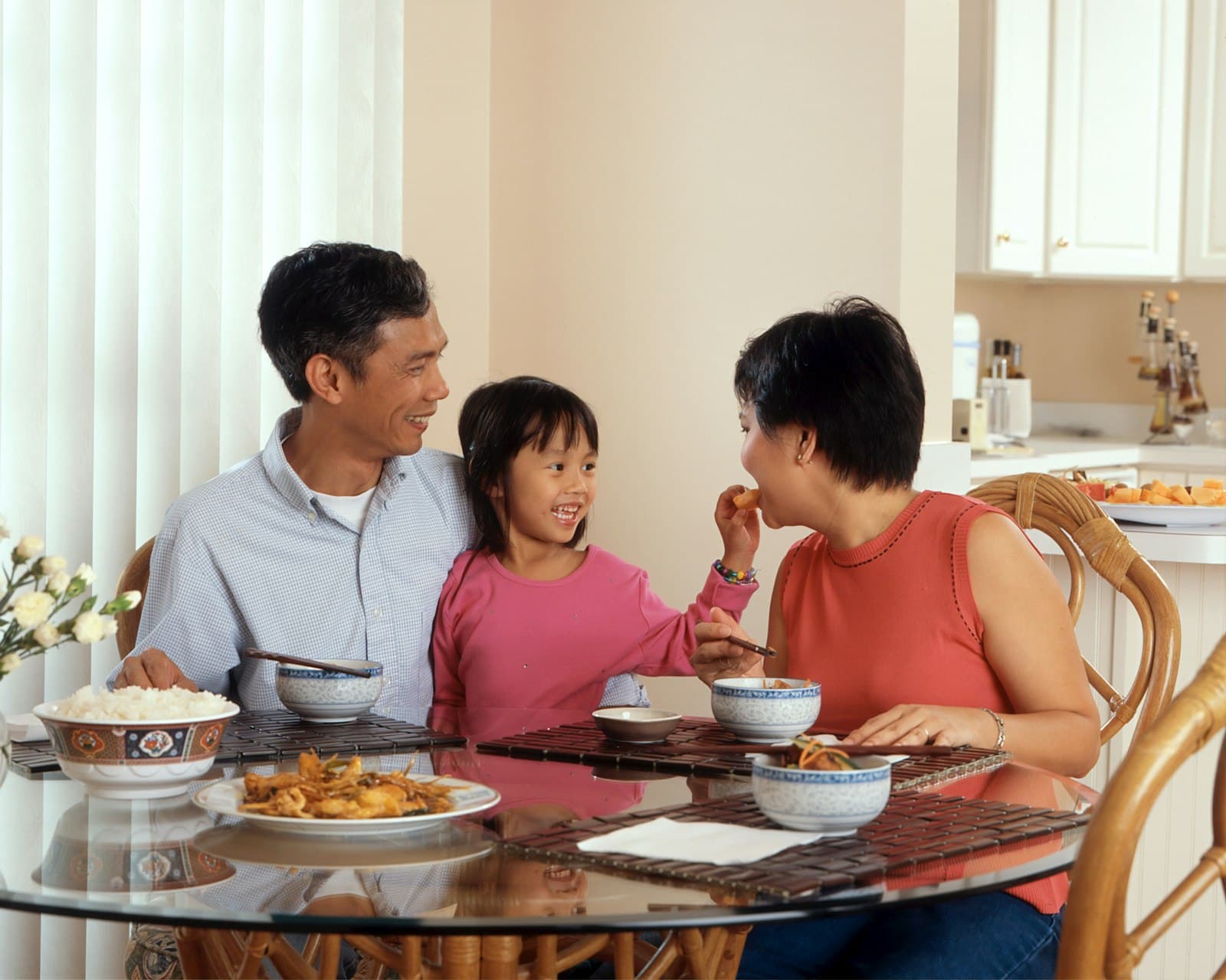 An aerial view of a shared family meal — the household as the unit of food.
