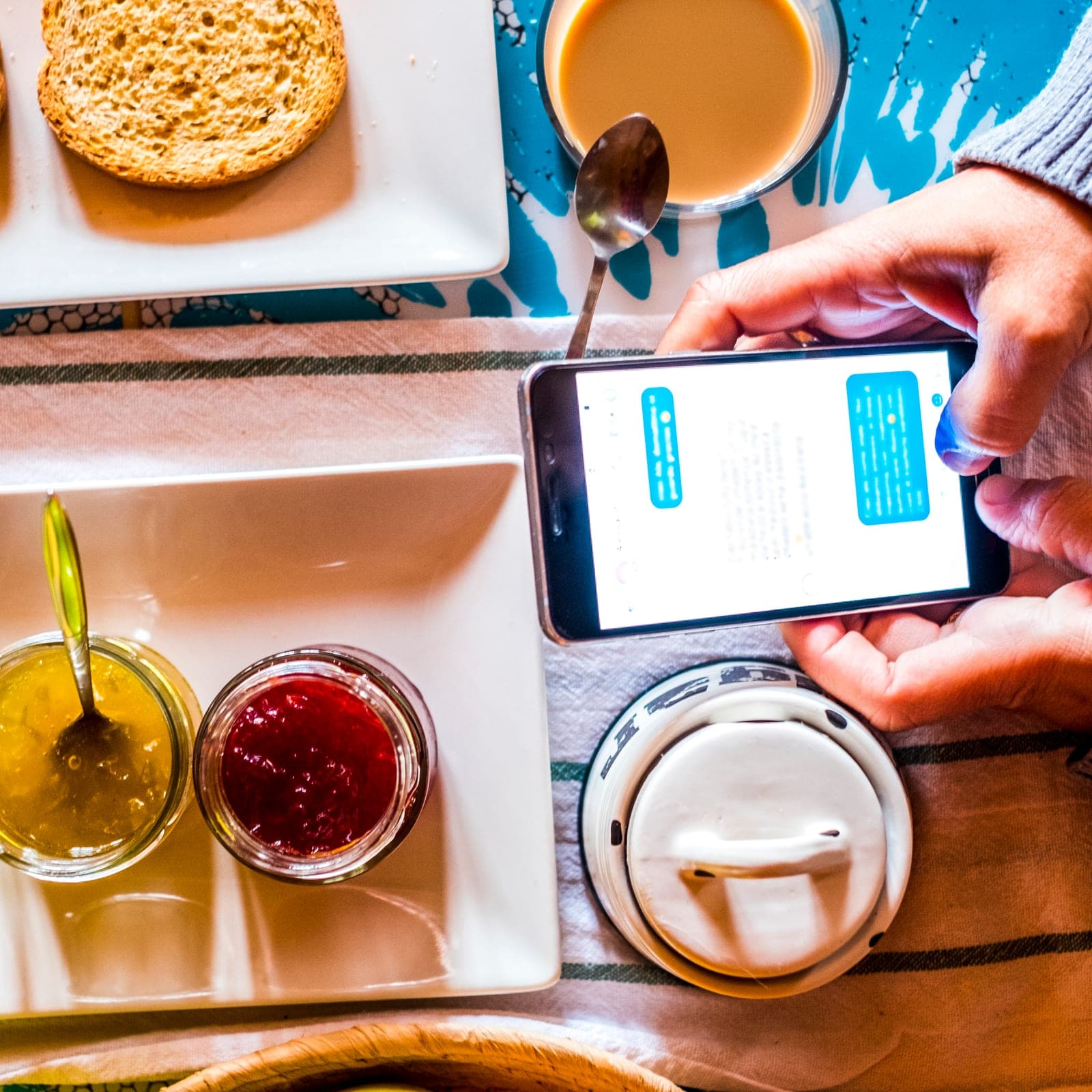Cook checking WhatsApp recipes on phone